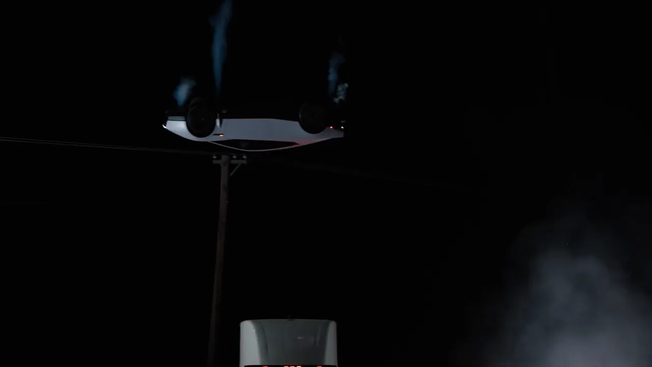 The Roadster upside down above the Semi, its underside and jets visible