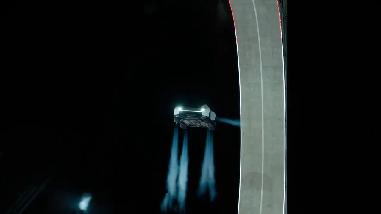The Roadster in mid-air beside the ramp, four jets firing downward from its underside